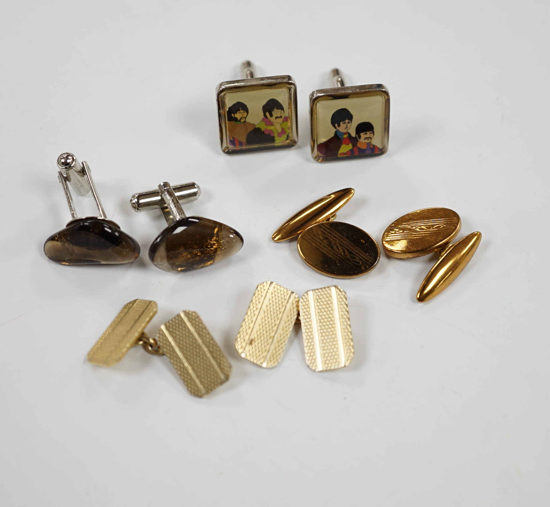 Four assorted pairs of gilt or base metal cufflinks including 'The Beatles'.